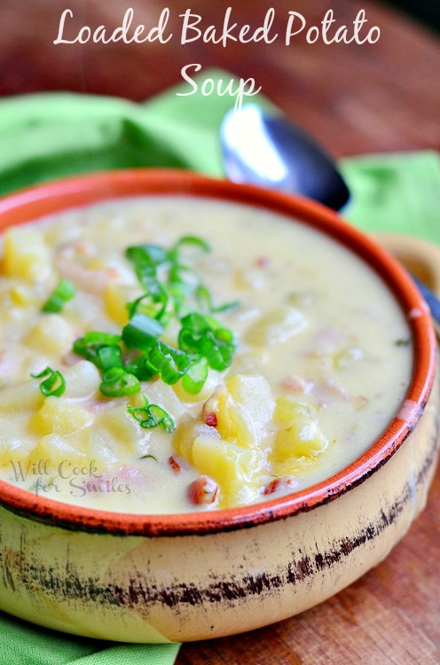 Baked Potato Soup with green onions on top in a bowl 