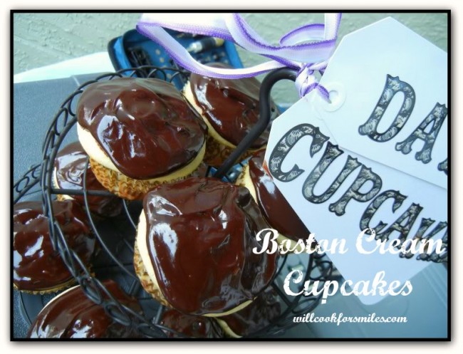 close up photo of cupcakes with chocolate on top in a cupcake stand with a sign on top that says dad's cupcakes 