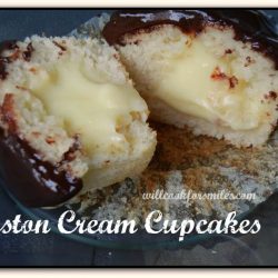 picture of 1 boston cream cupcake split in half on a glass plate