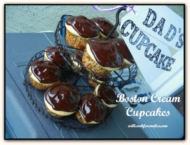 cupcakes with chocolate on top in a cupcake stand with a sign on top that says dad's cupcakes 