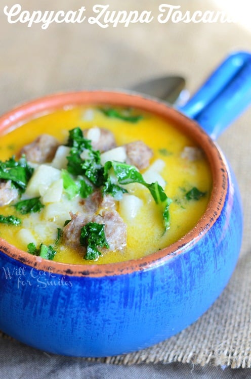 Copycat Zuppa Toscana with sausage and kale in a blue bowl 