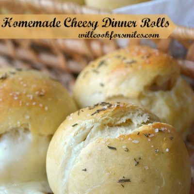 close up shot of 3 cheesy dinner rolls on front of basket holding 7 cheesy dinner rolls