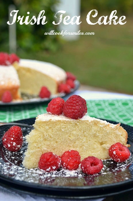 Irish Tea cake with raspberries on a black plate 