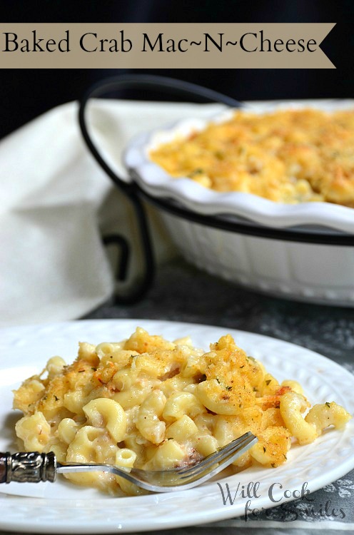 Baked Crab Mac N Cheese on a white plate with a fork across it 