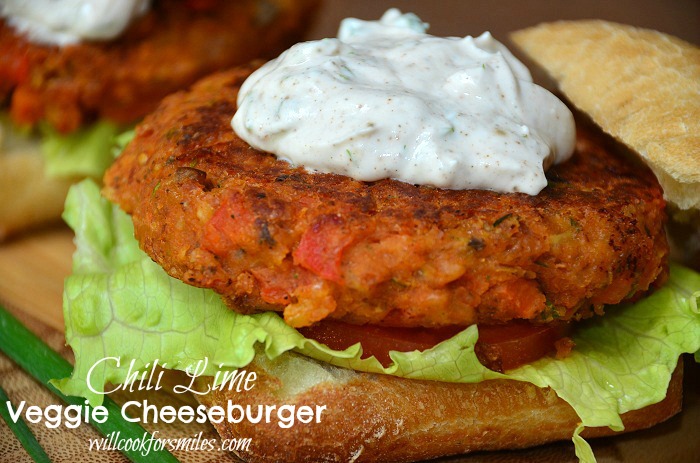 2 chili lime burgers on buns with creamy topping on wood cutting board