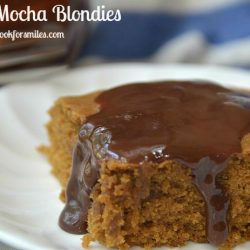 1 coffee mocha blodie with syrup on white plate with fork in background out of focus