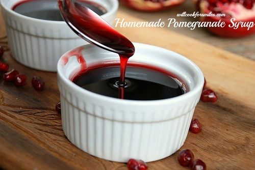 pomegranate syrup being spooned into a glass ramekin 