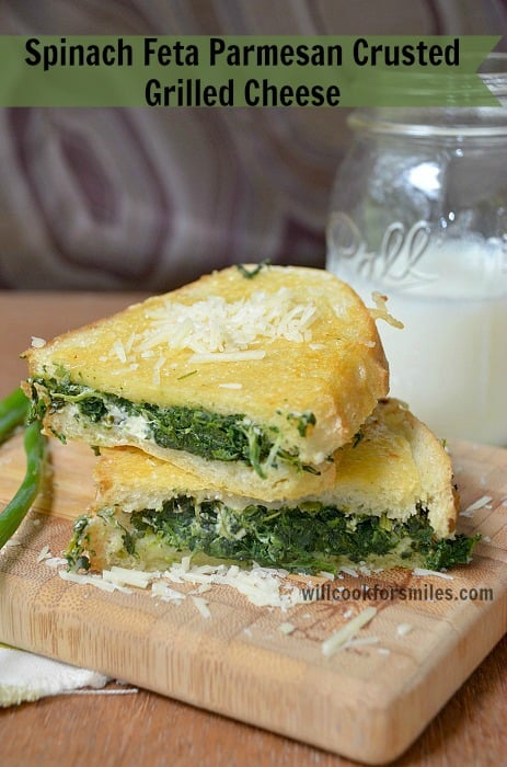 Spinach Feta Parmesan Crusted Grilled Cheese on a cutting board 