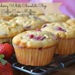 Strawberry-White-Chocolate-Chip-Coffee-Cake-Muffins sitting on metal grate with strawberries in front left
