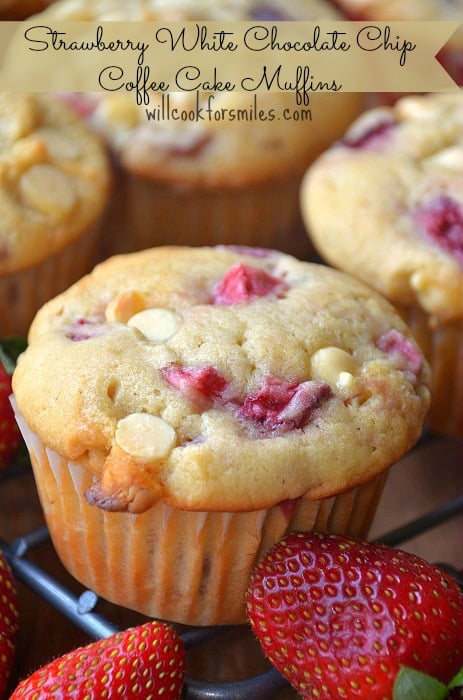 Strawberry Muffins on a cooling rack with strawberries 