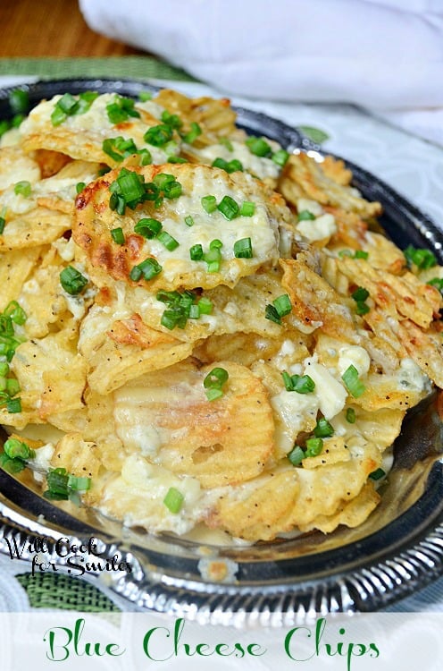 close up shot, shot from above silver platter with blue cheese chips on a white and green cloth