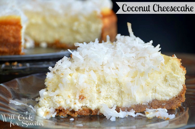 close up shot of 1 slice of coconut cheesecake on a glass plate in forground with 1 whole coconut cheesecake 1 slice missing on round glass platter in background