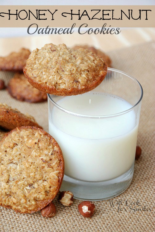 cookies on a piece of burlap with a glass of milk with a cookie on the edge 