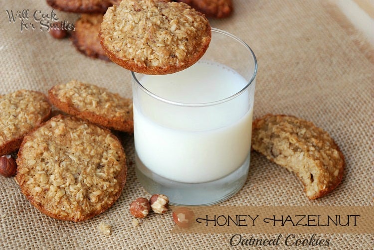 cookies on a piece of burlap with a glass of milk with a cookie on the edge 