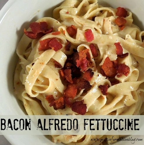 bacon alfredo fettuccine in a white bowl 