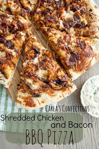bbq chicken pizza sliced up on a wood table with a green napkin 