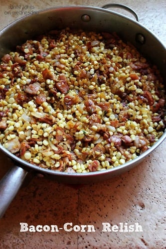 bacon and corn in a metal pan on a counter top 
