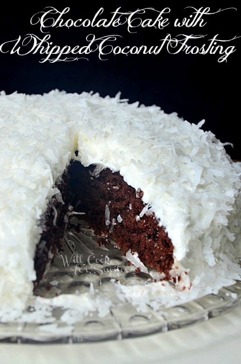 shot from front whole cake with 1 slice removed from front on glass plate