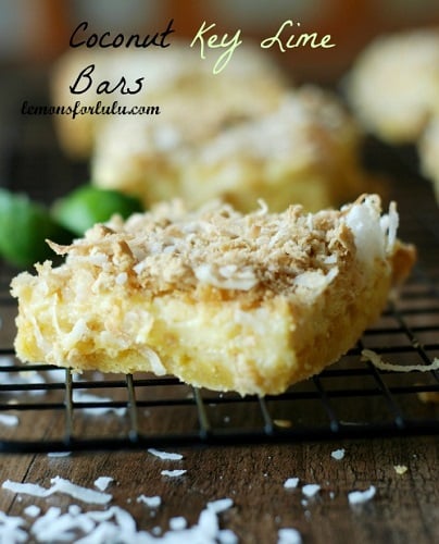 Coconut Key Lime Bar slice on a cooling rack with coconut shavings under it 