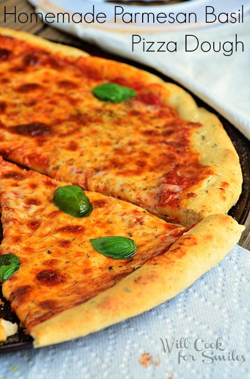 pizza with basil on top with a napkin in front of it 