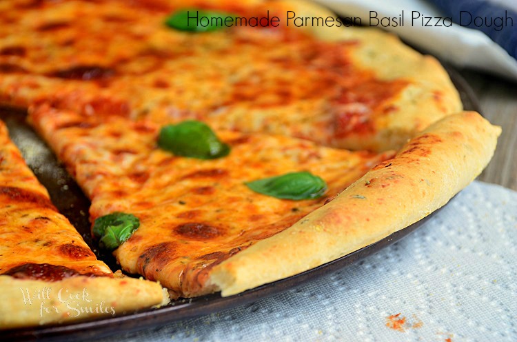 cheese pizza cut into slices on a pizza pan with a napkin under the pan 