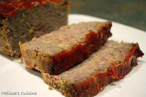 slices of meatloaf on a white plate 