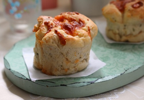 baked bacon pastries on blue wood tray 