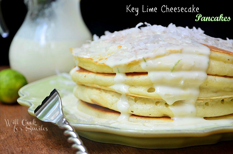 Key Lime Cheesecake Pancakes topped with key lime cheesecake sauce on a green plate 