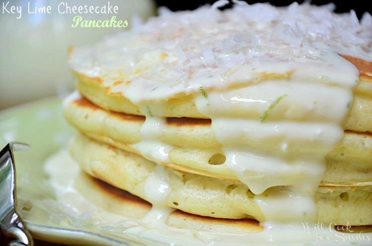 Key Lime Cheesecake Pancakes topped with key lime cheesecake sauce on a green plate close up