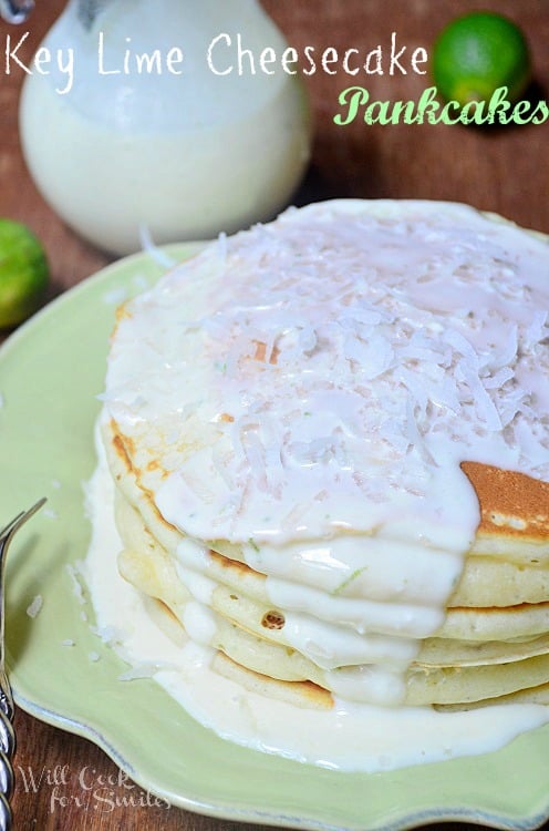 Key Lime Cheesecake Pancakes topped with key lime cheesecake sauce on a green plate 
