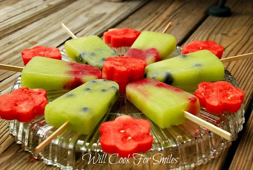 Melon Berry ice Pops  on top of a glass platter 