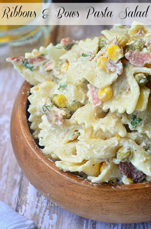 bow tie pasta in a woof bowl with corn and peas 