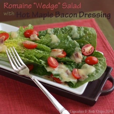 Romaine wedge salad with tomatoes and dressing over it with a fork to the left of the plate 