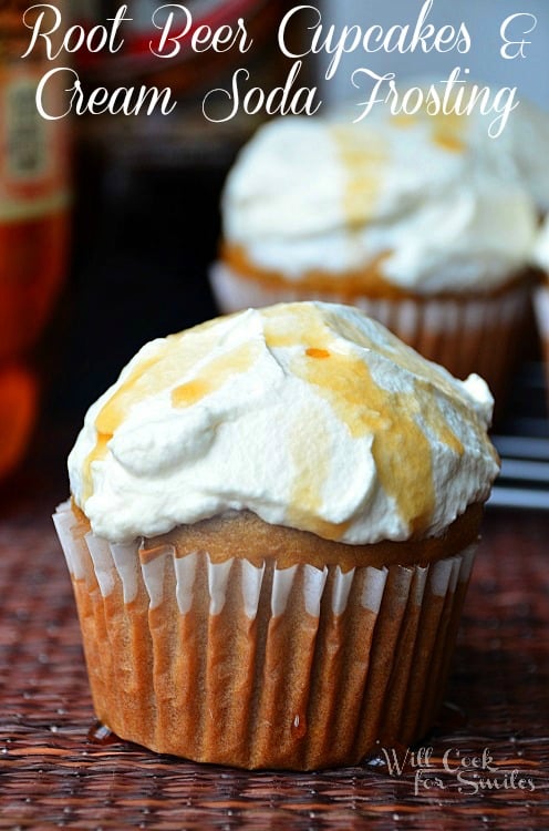 close up shot of root beer cupcakes with additional cupcakes in background and 2 2 liters of soda to the left in back ground