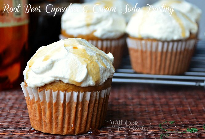 close up shot of root beer cupcakes with additional cupcakes in background and 2 2 liters of soda to the left in back ground