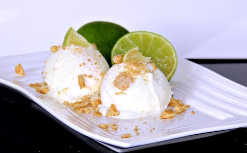 key lime ice cream on a plate with limes cut up 