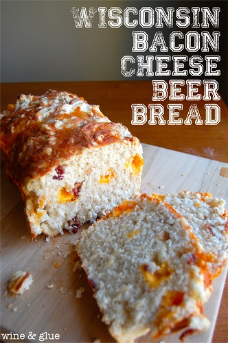 sliced bacon cheese beer bread on wood cutting board shot from slightly above and front view