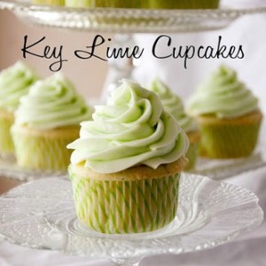 key lime cupcakes on a glass plate and the rest in the background on a cupcake platter 
