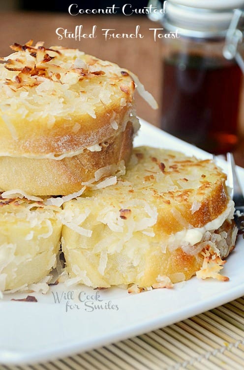 Coconut French toast stacked on a white plate.