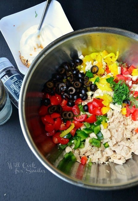 ingredients laid side by side in a bowl and a bowl of Greek yogurt mixture next to it