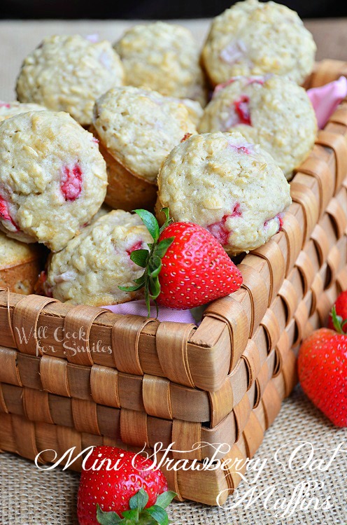 Mini Strawberry Oat Muffins in a basket with strawberries around it 