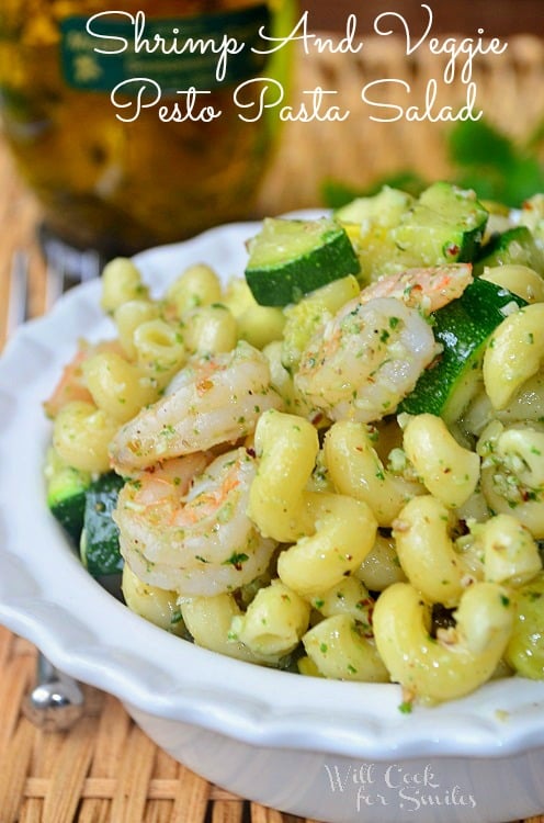 shrimp and veggie pesto pasta salad in a white bowl 