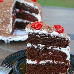 1 slice of cake in front of whole cake in the background