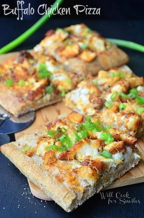 Buffalo Chicken Pizza squares on a cutting board 