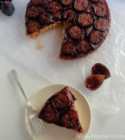 Fig-Upside-Down-Cake-slice on a plate with the rest of the cake above it on wax paper 