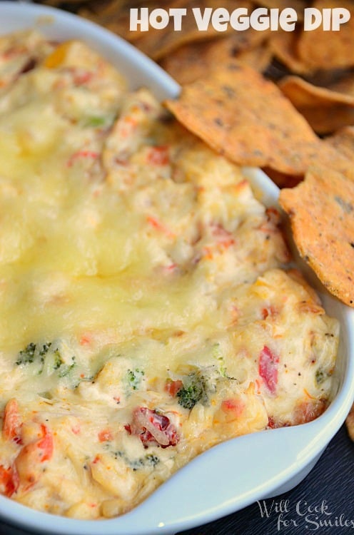Hot Vegetable Dip in a casserole dish with chips to the right 