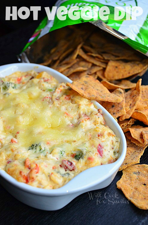 Hot Vegetable Dip in a casserole dish with chips to the right side