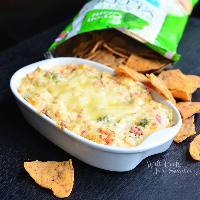 Hot Veggie Dip in a casserole dish with chips all around it 