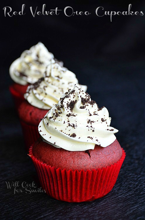 Red Velvet Oreo Cupcakes with white frosting and oreo crumbs sprinkled on top 