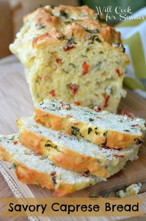 Savory Caprese Bread sliced on a cutting board 